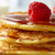 Pancakes stacked with a raspberry on top